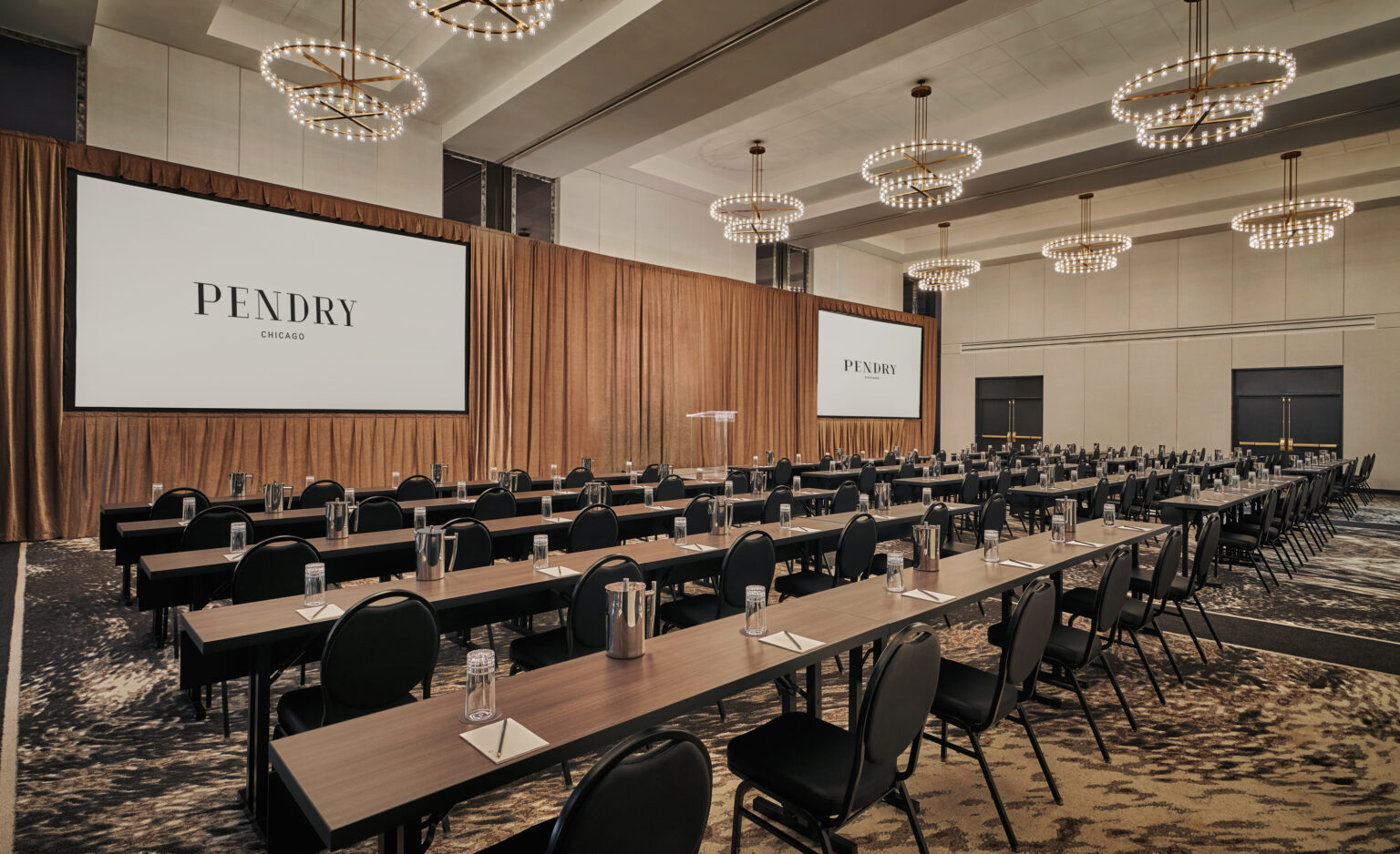 Ballroom set up with chairs and a podium for a meeting