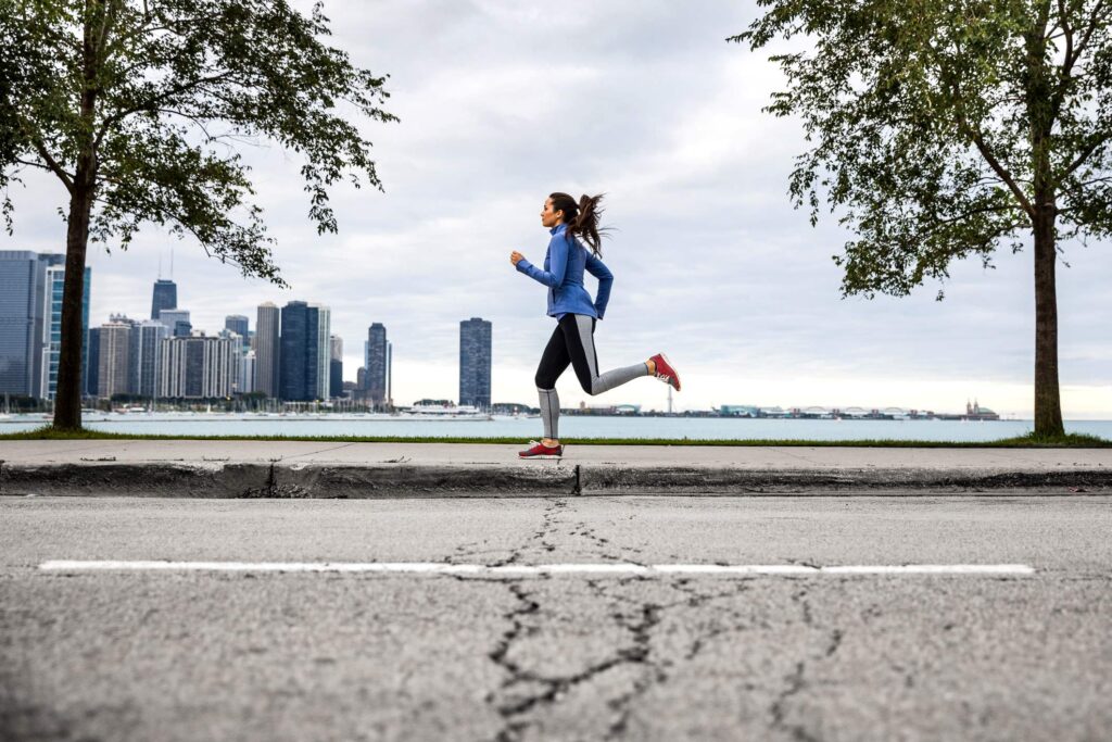Woman running on lake michigan shoreline in Chicago