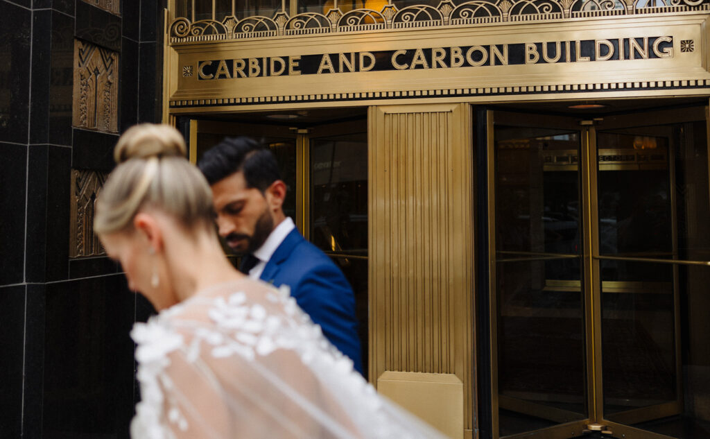 Bride and groom standing outside the Carbide and Carbon Building.