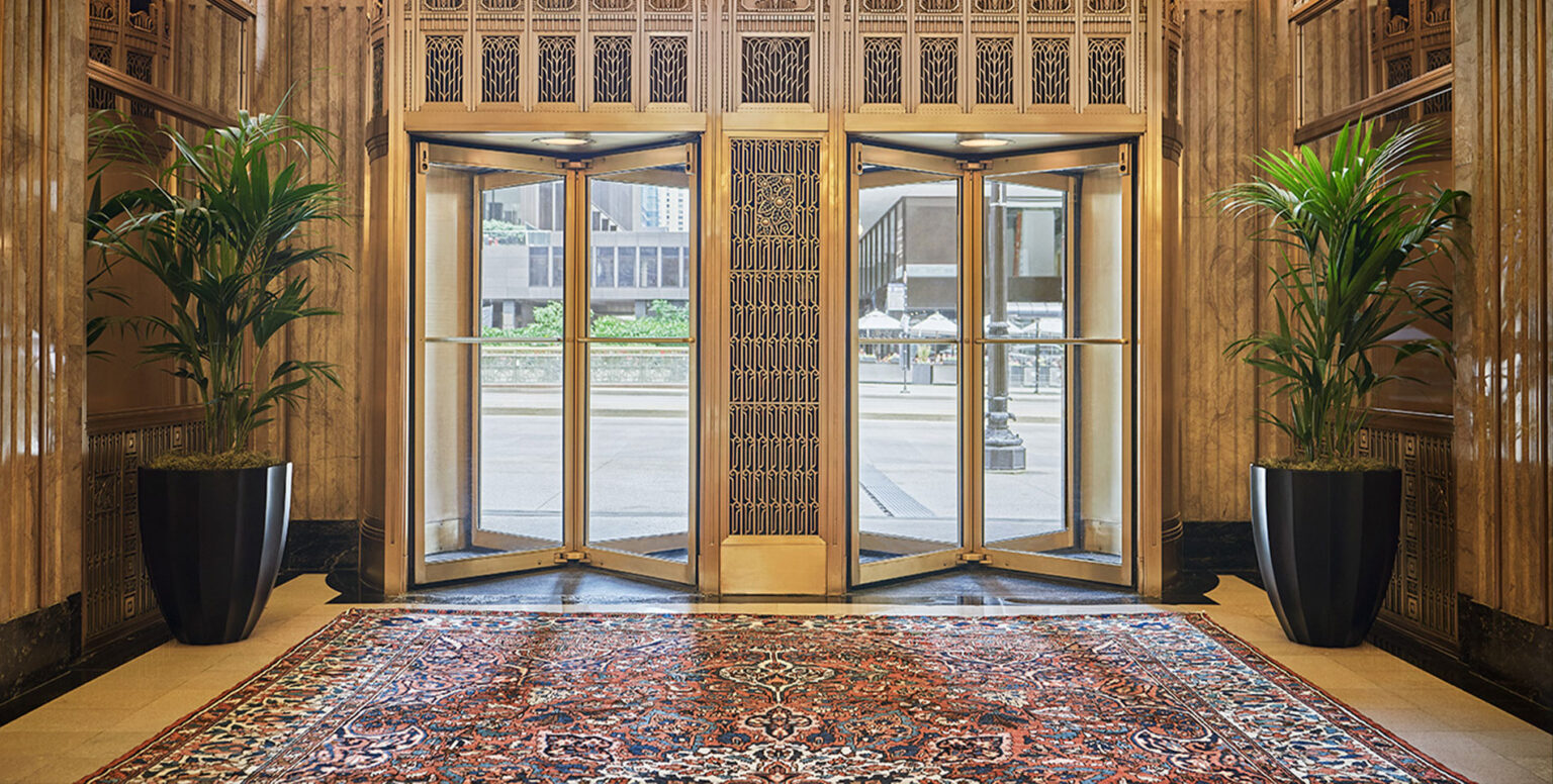 Golden revolving doors in the lobby of Pendry Chicago hotel on Michigan Avenue