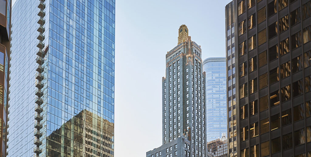 The exterior of Pendry Chicago surrounded by downtown Chicago skyscrapers on North Michigan Avenue