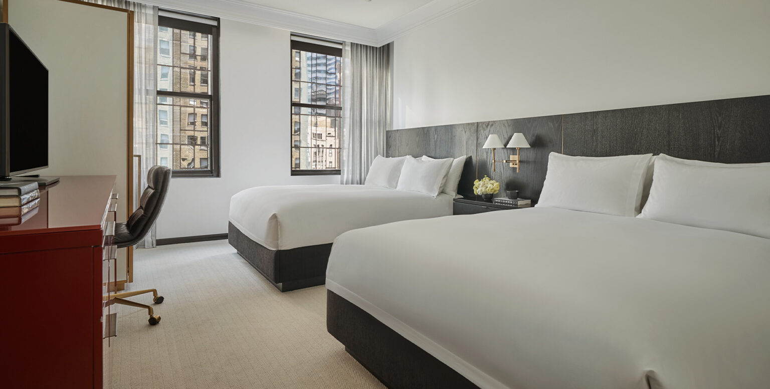 Two queen beds in a guestroom at Pendry Chicago hotel
