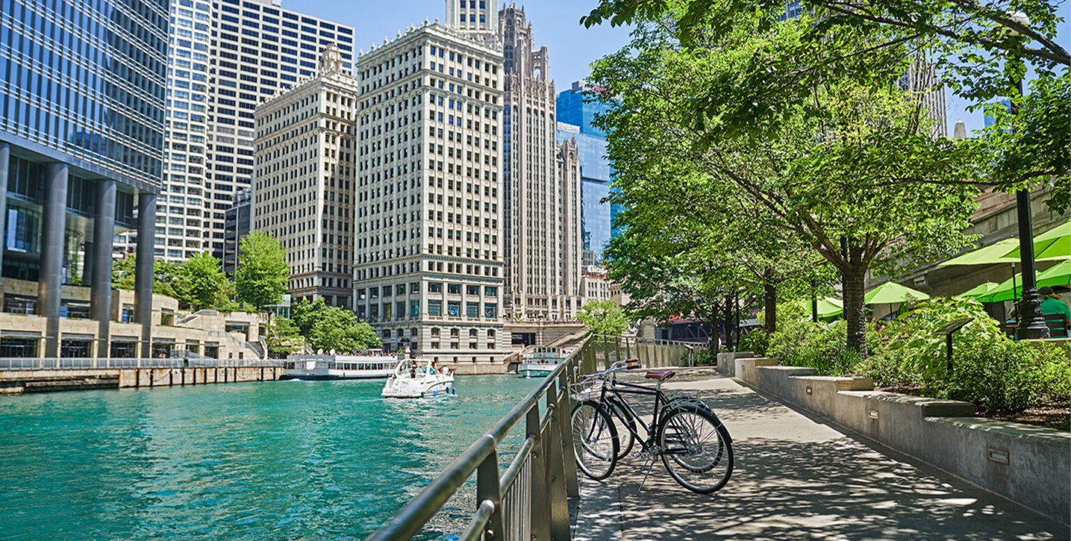 Two bikes leaned against a railing by the Chicago River