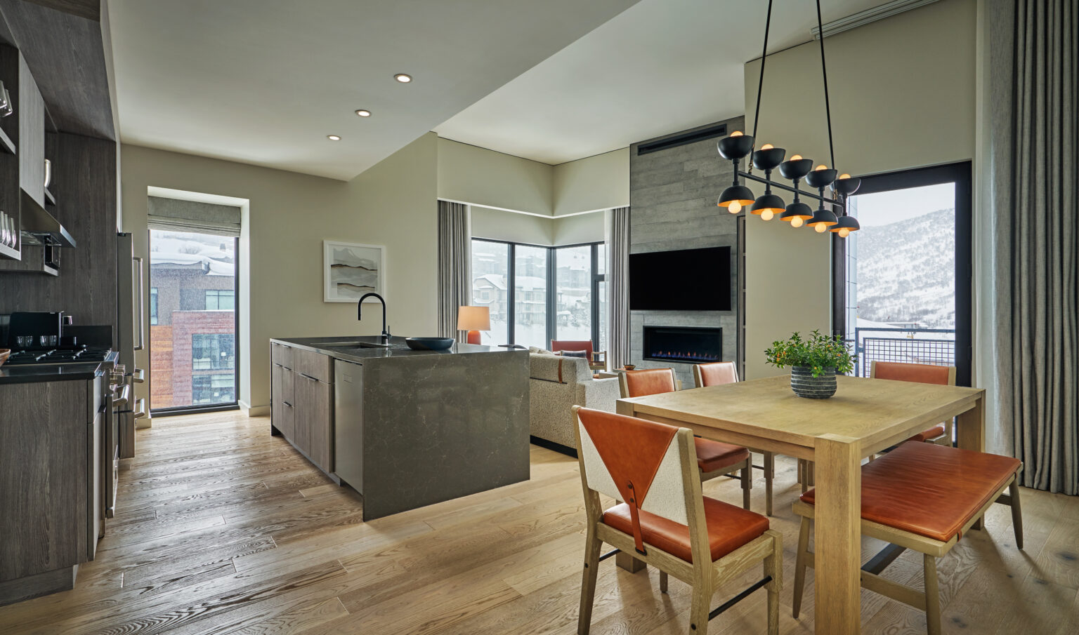 A kitchen and a living room view of suite at Pendry Park City