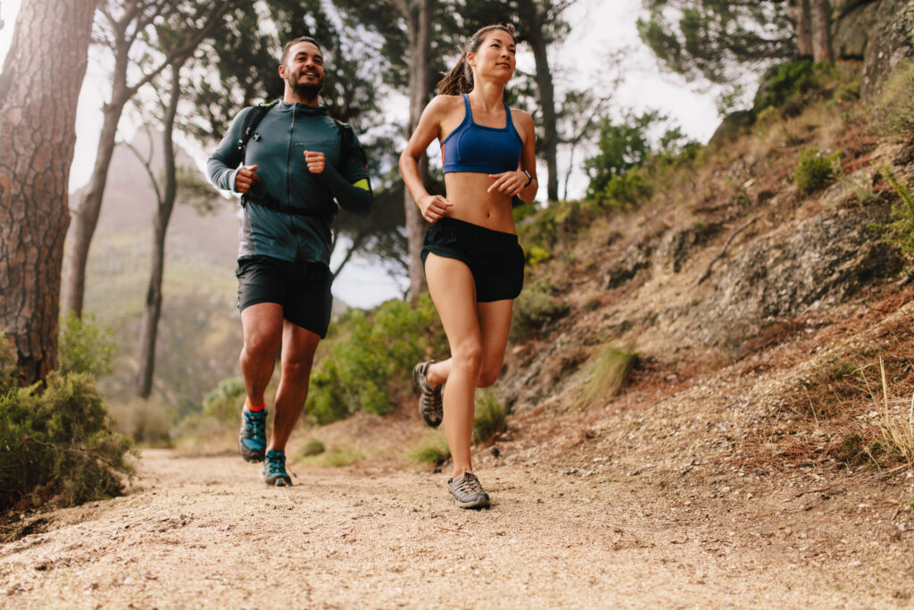 A couple running on a trail together