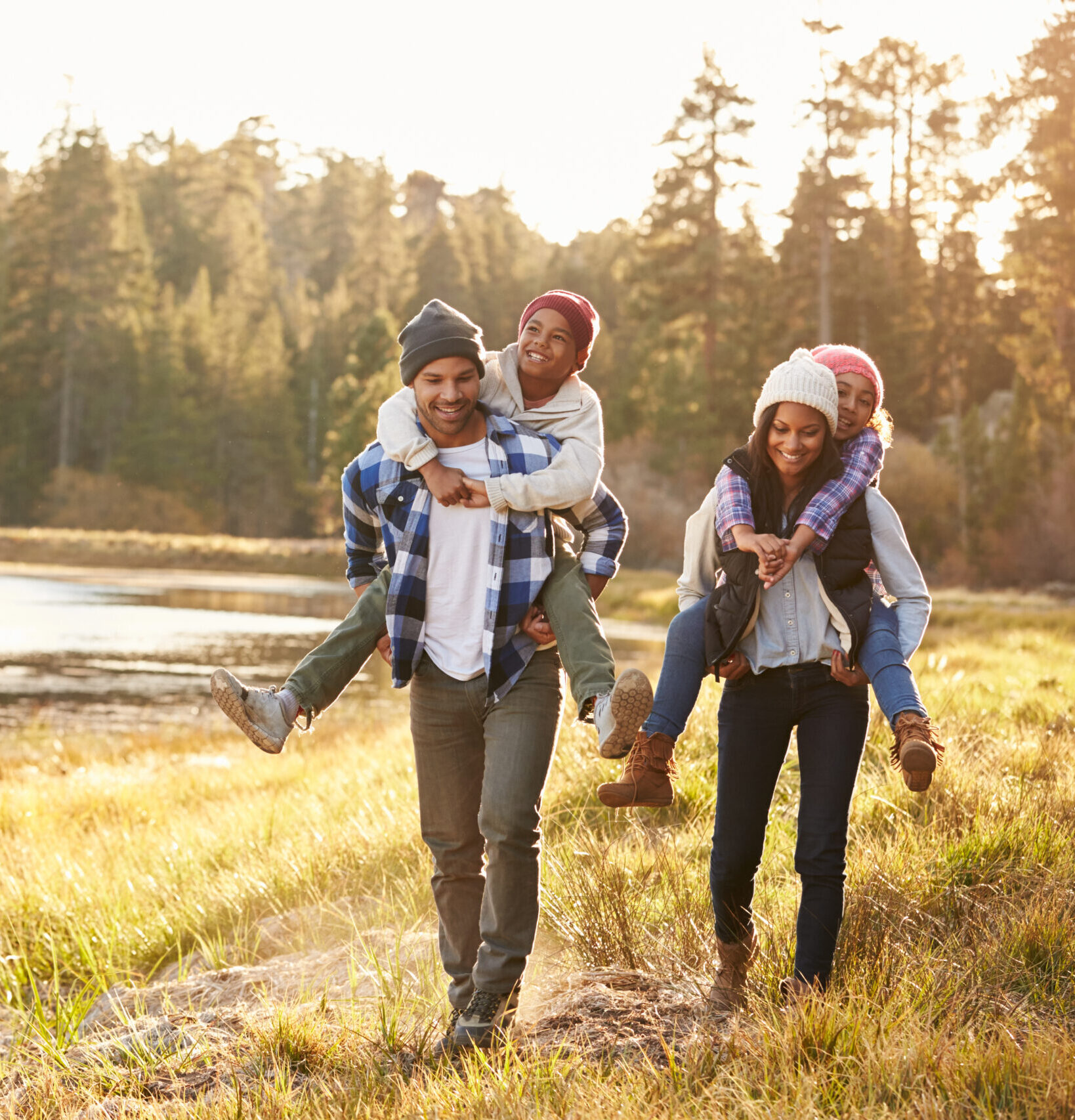 Fall Parents giving children piggy back rides