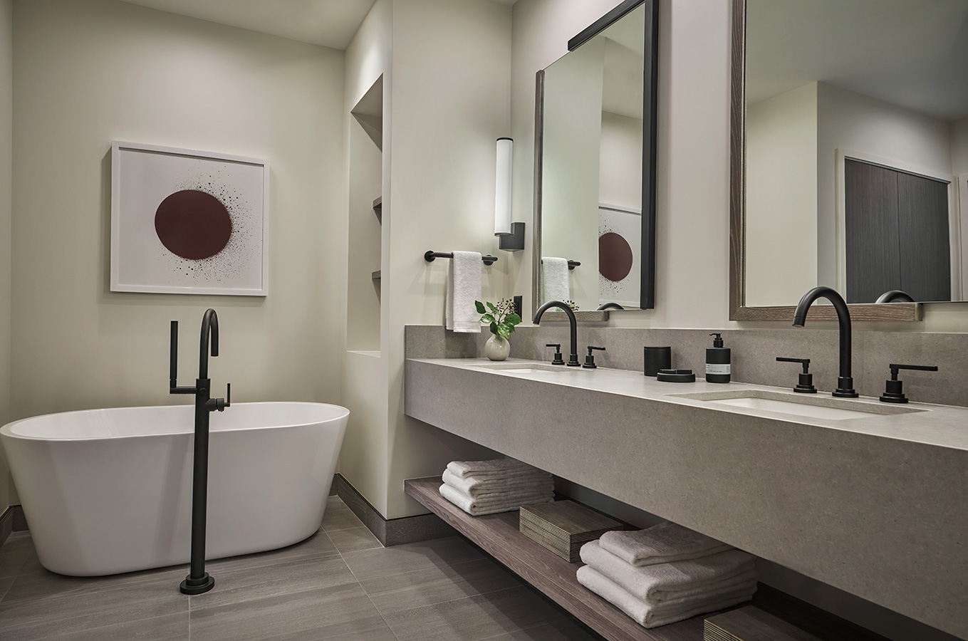 A luxury bathroom with a bath tub and two sinks at Pendry Park City