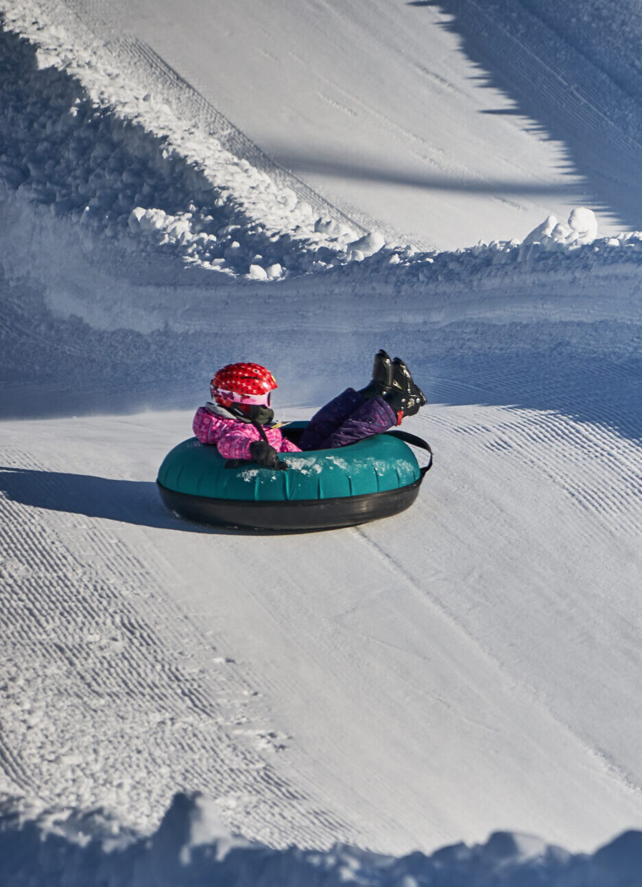a child snowtubing