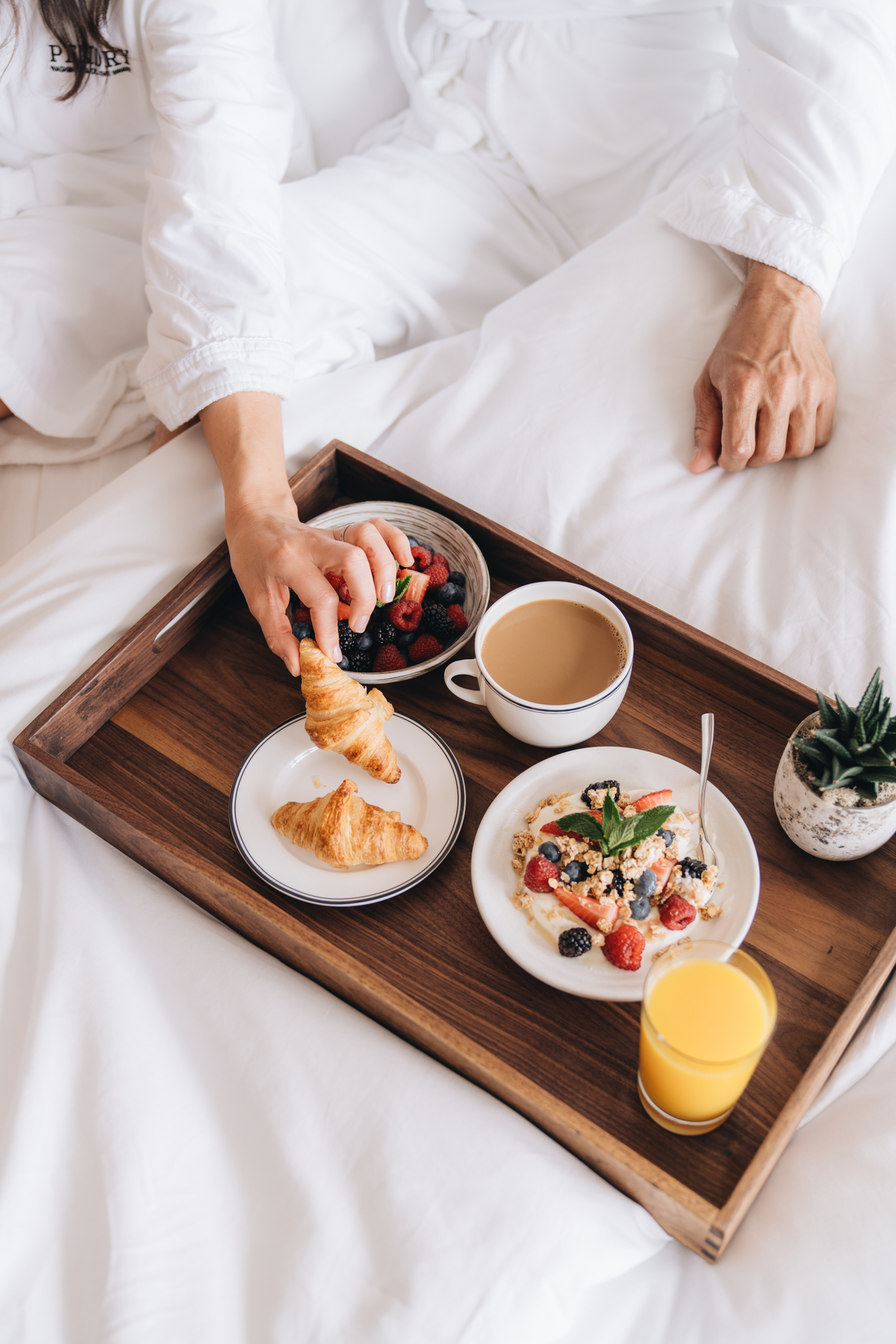 A couple eating breakfast in bed at Pendry Park City