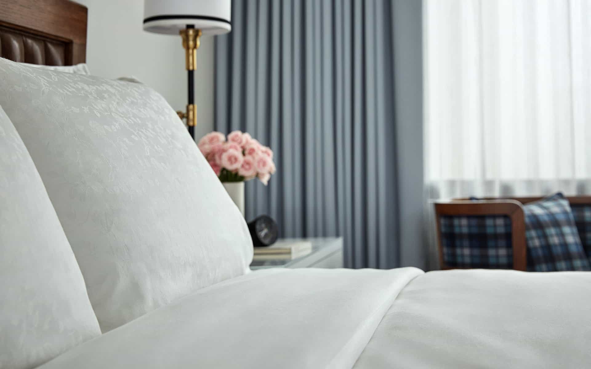 Pillow and bedding detail of hotel room at Pendry San Diego, a luxury Gaslamp boutique hotel