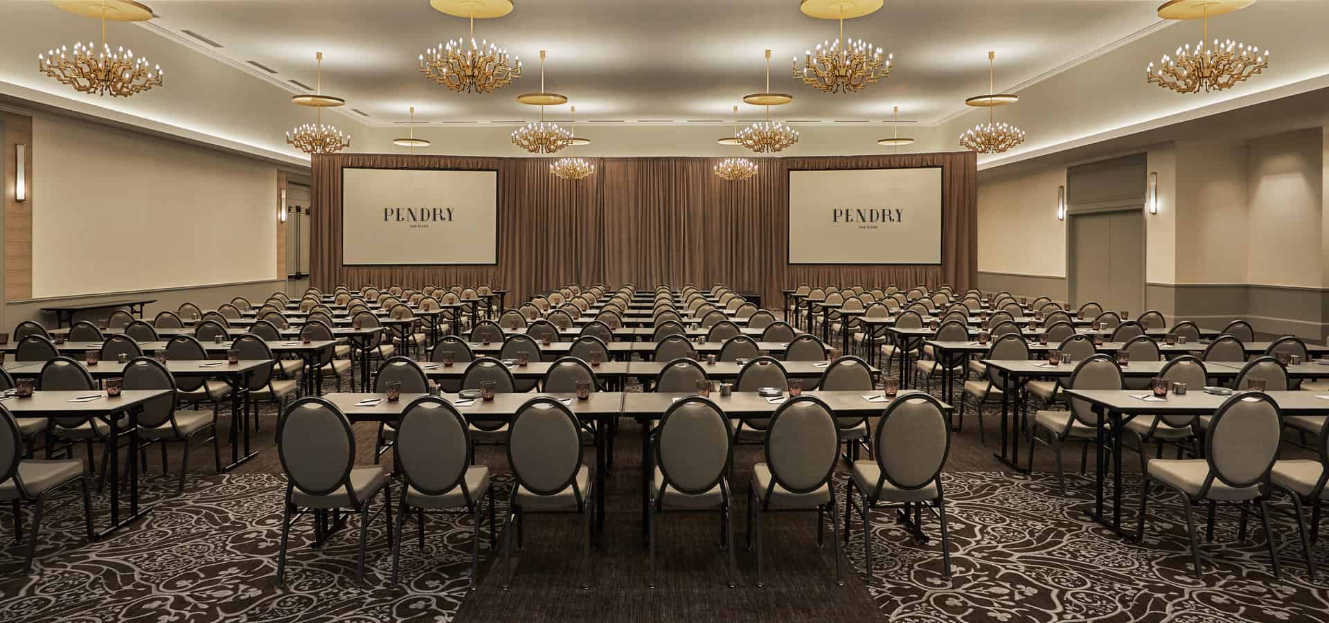 Event room with seating and projector in downtown San Diego luxury hotel