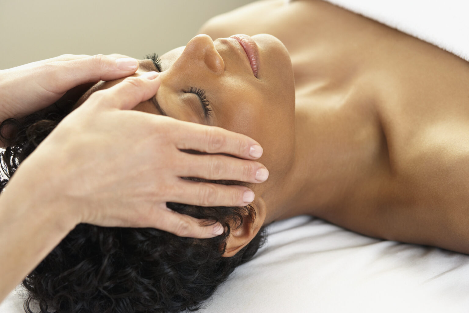 Woman receiving a facial at a luxury hotel spa in San Diego