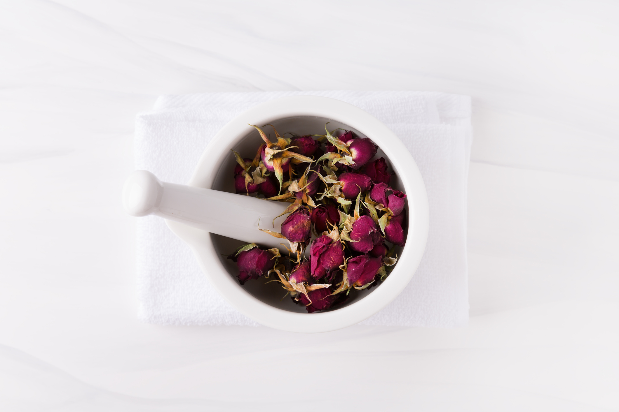 Dry rose petals in a mortar