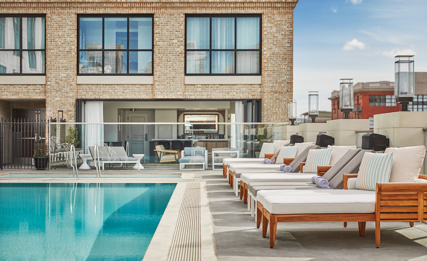 View of tanning chairs by the pool at Pendry San Diego
