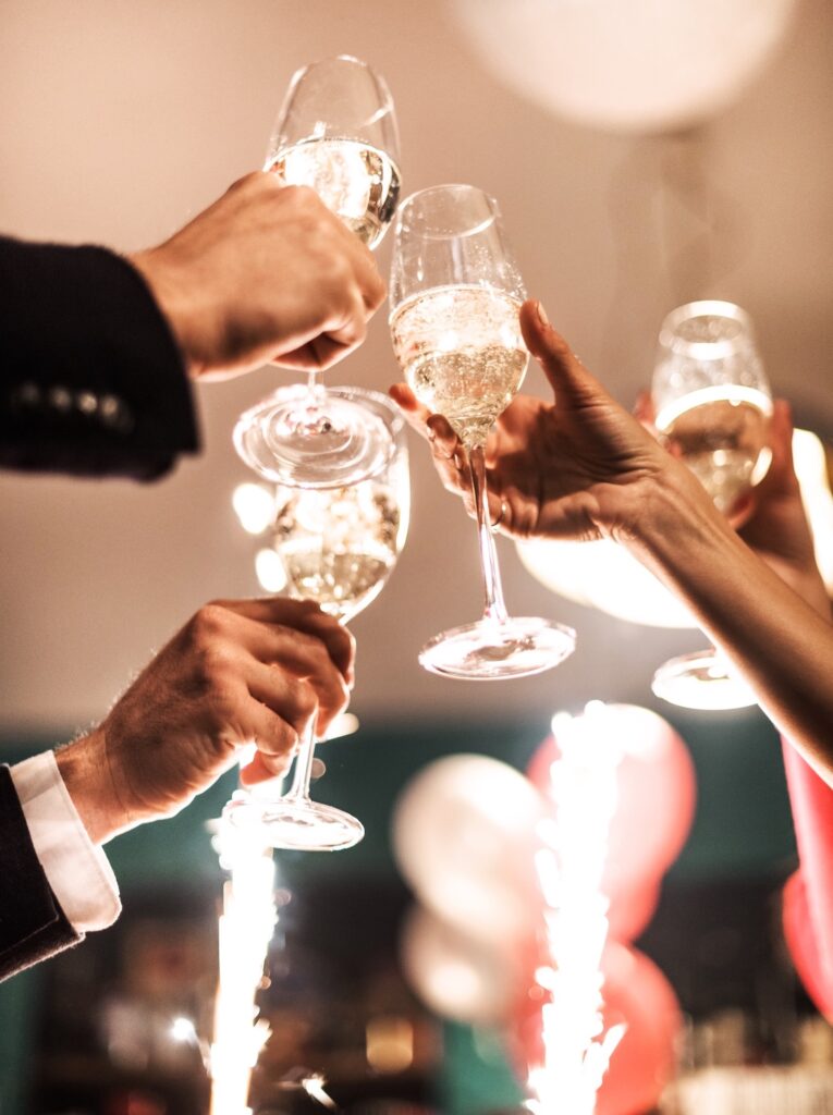 People clinking champagne glasses in a festive celebration