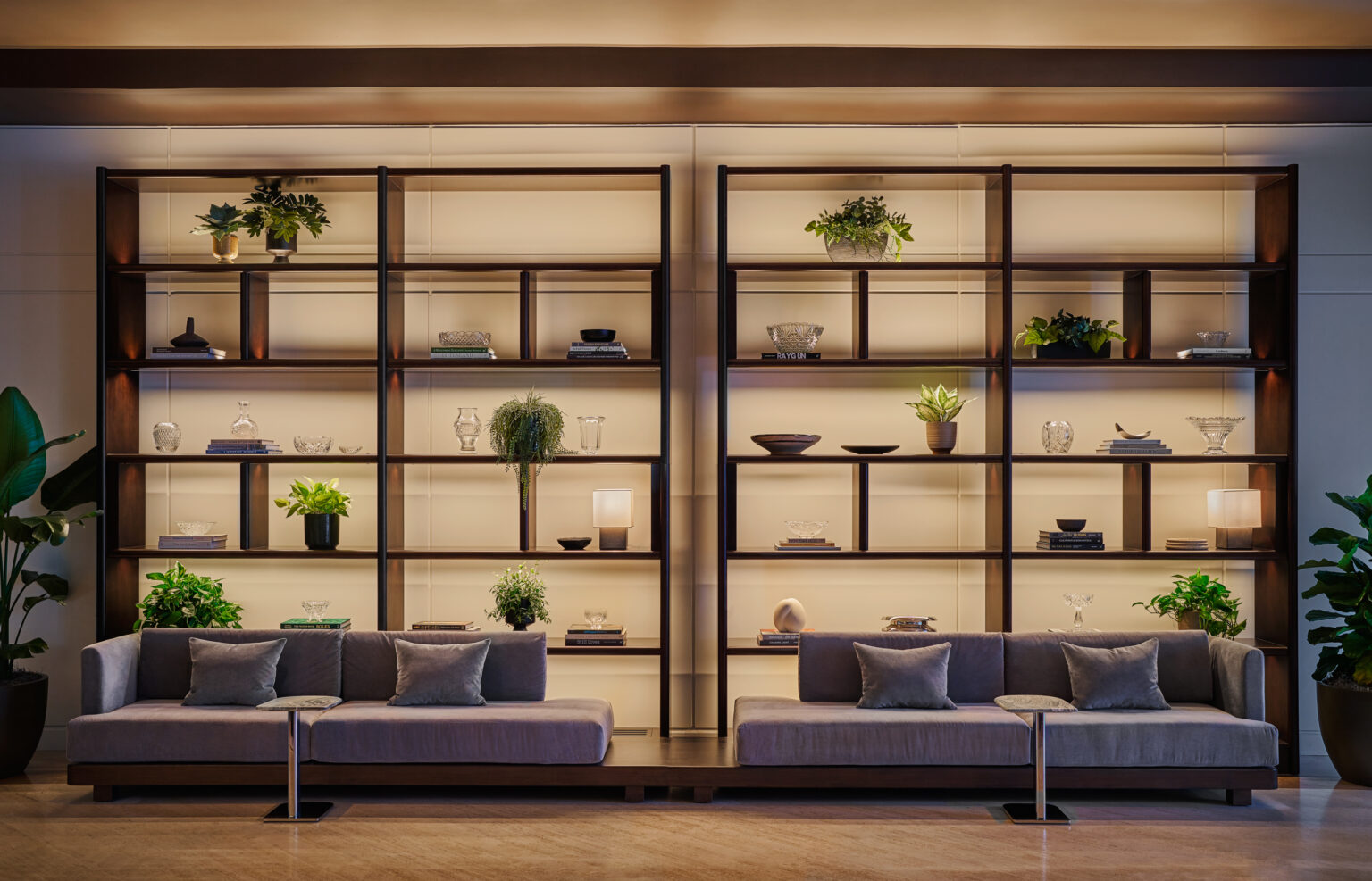 Lobby at Pendry Newport Beach resort, with couches and decorated bookcase