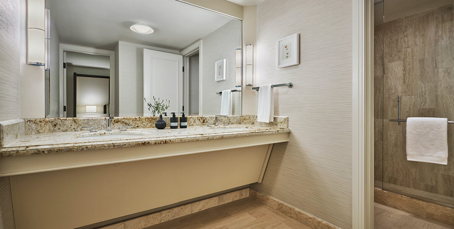 A marble double vanity in a bathroom of a guestroom at Pendry Newport Beach
