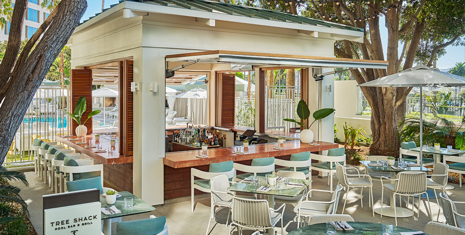 An outdoor bar with seating around it at Pendry Newport Beach