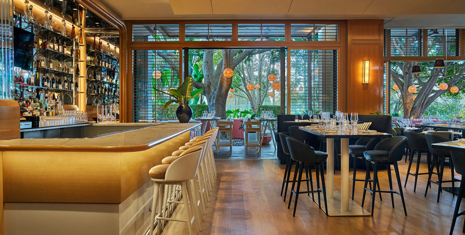 A golden accented bar at SET Steak & Sushi inside Pendry Newport Beach resort