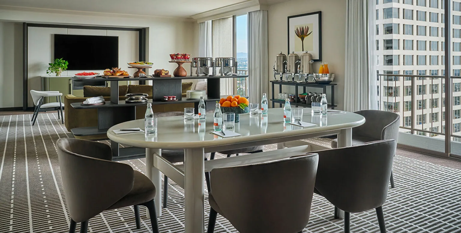A hospitality room with a dining table and buffet at Pendry Newport Beach