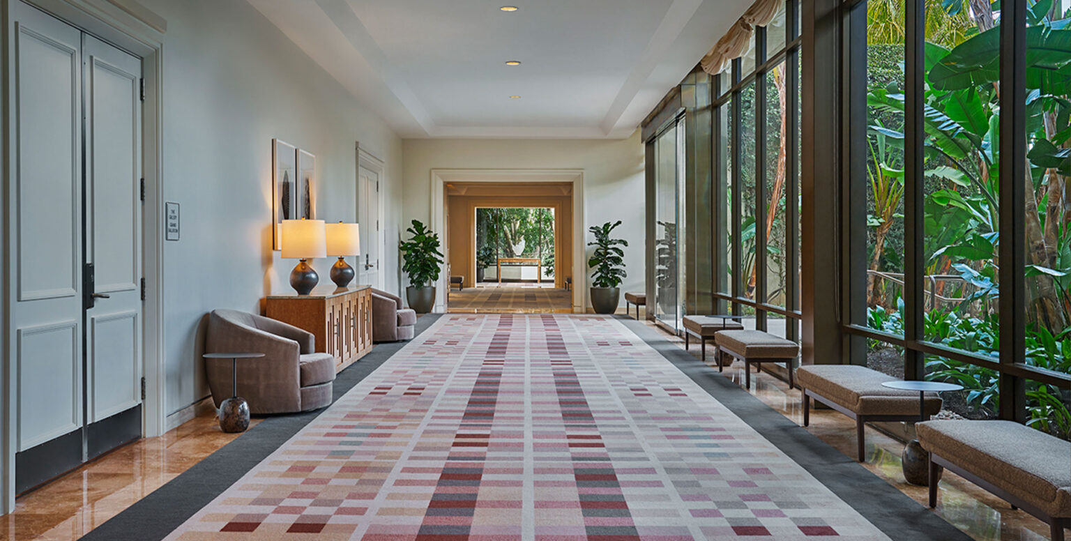 A pre-function hallway with floor-to-cieling windows at Pendry Newport Beach