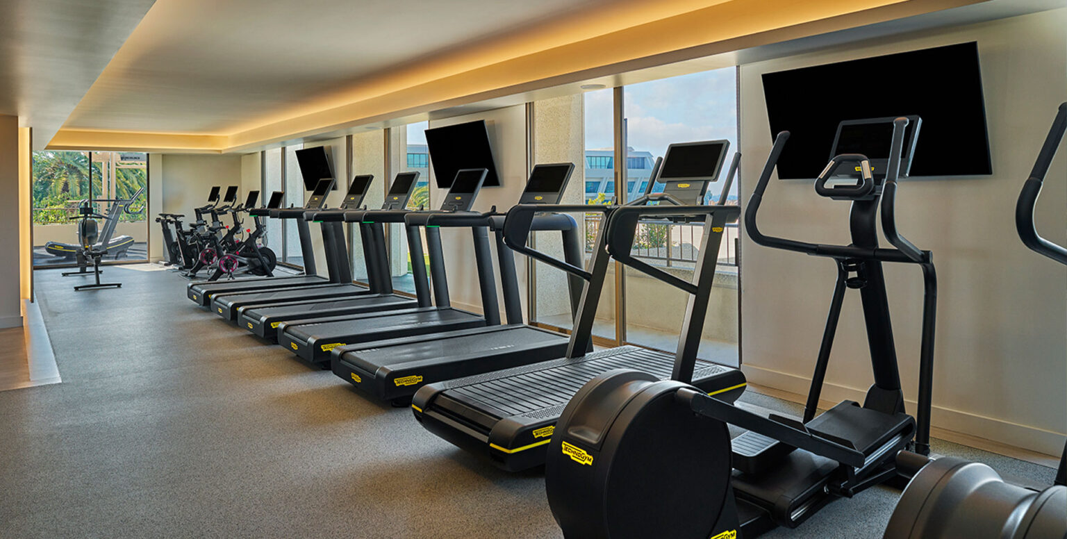 Treadmills and other workout equipment at the hotel gym in Pendry Newport Beach