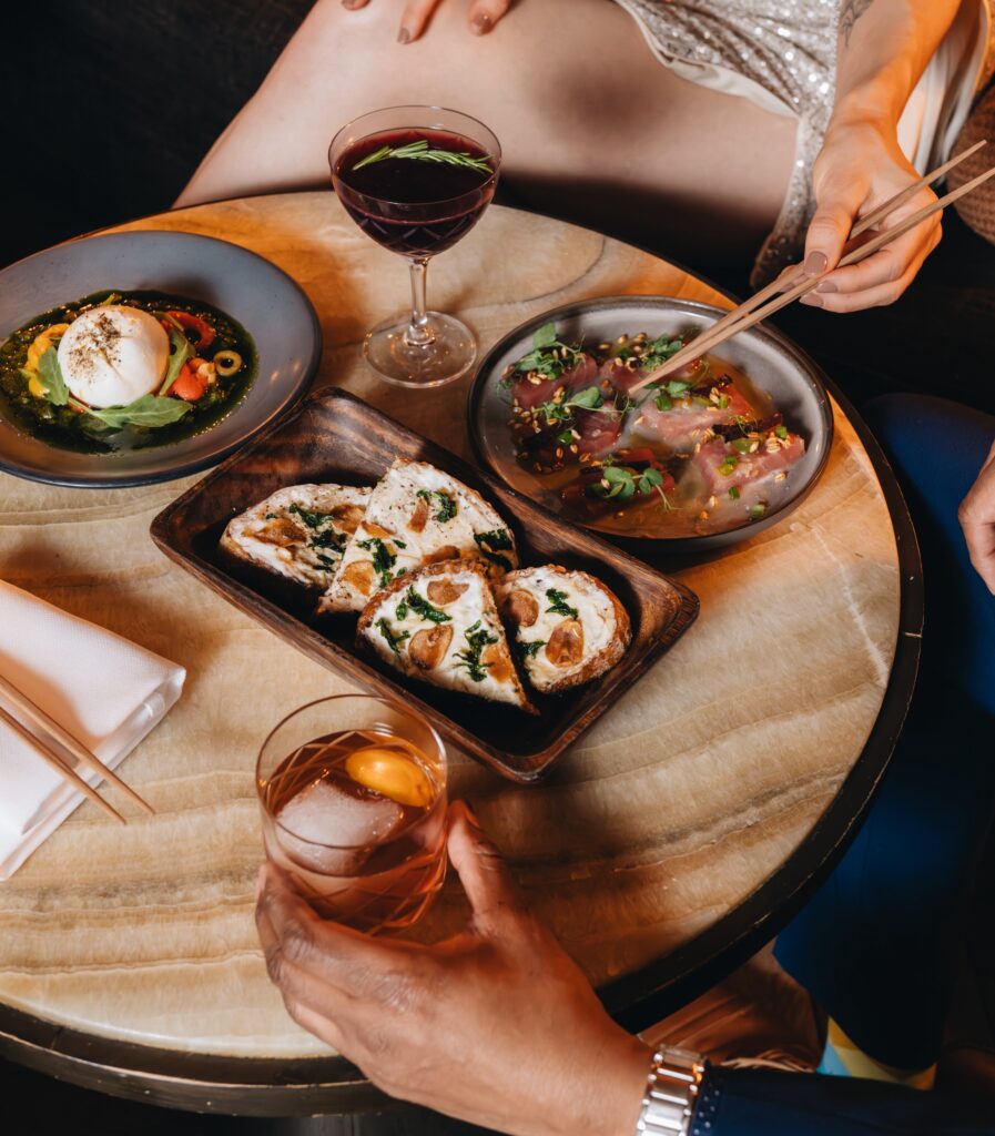 two people enjoying gourmet sushi and cocktails