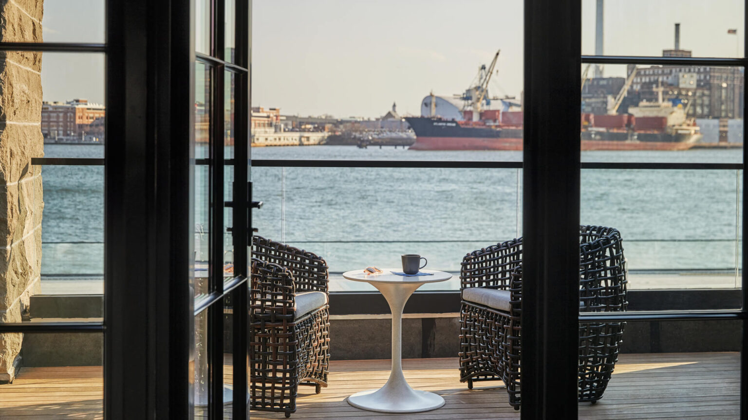 A room balcony overlooking the harbor at Pendry Baltimore hotel.
