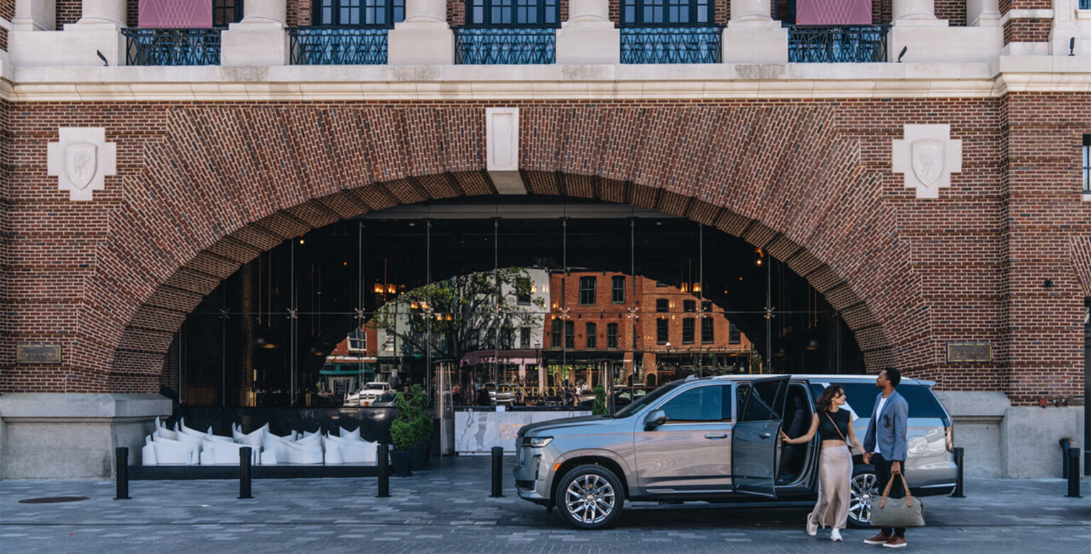 A couple getting out of their Cadillac in front of Pendry Baltimore