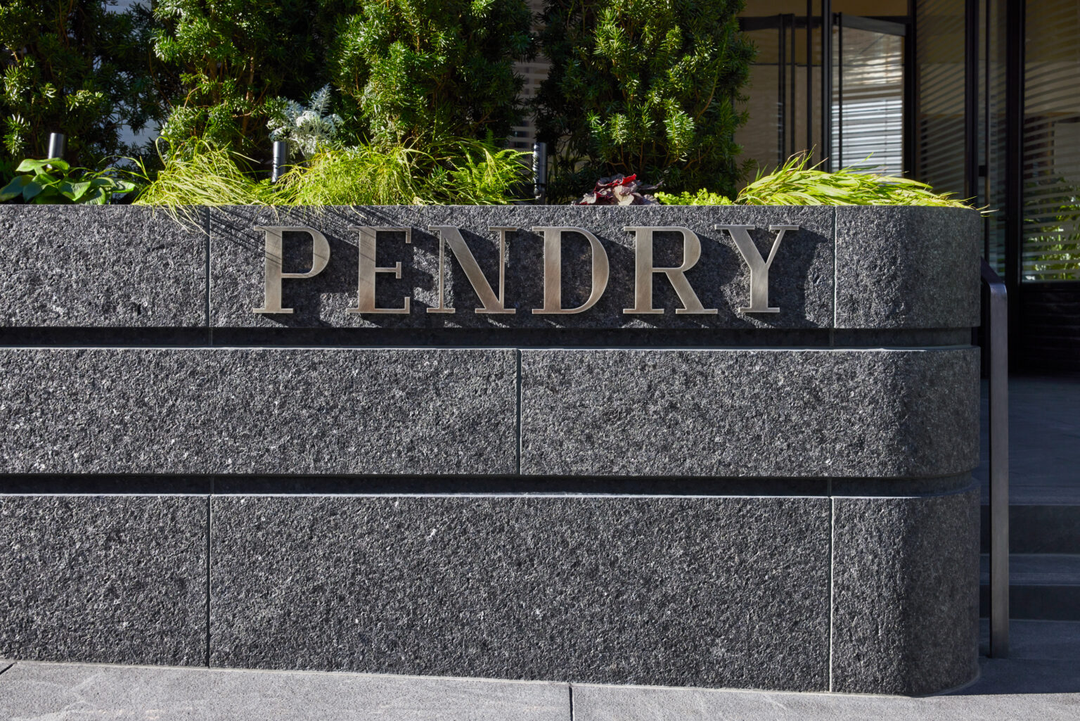 Pendry sign, with greenery and trees above it