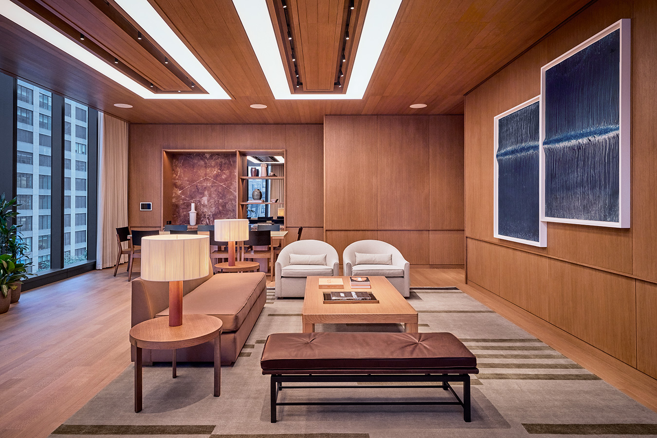 The Gallery at Pendry Manhattan West featuring modern furniture, warm wood paneling and contemporary artwork.