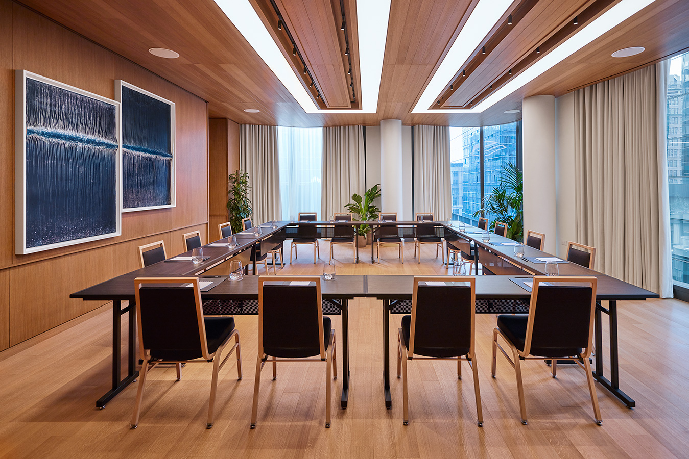 Modern meeting room at The Gallery with floor-to-ceiling windows, natural light and a U-shaped table setup at Pendry Manhattan West.