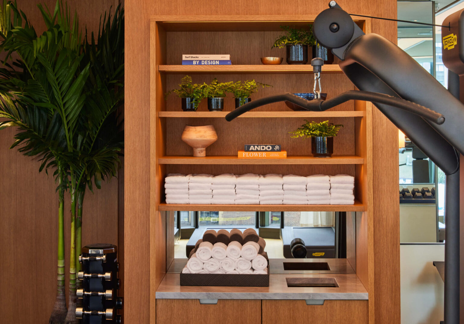 Fitness Center at Pendry Manhattan West with rolled towels, dumbbells and gym equipment.