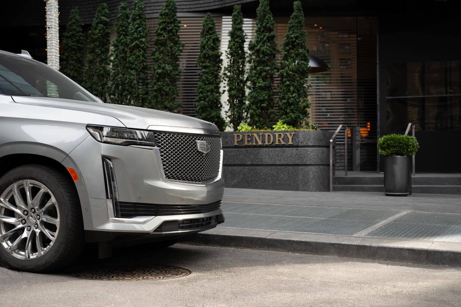 A silver Cadillac SUV outside of Pendry Manhattan West.