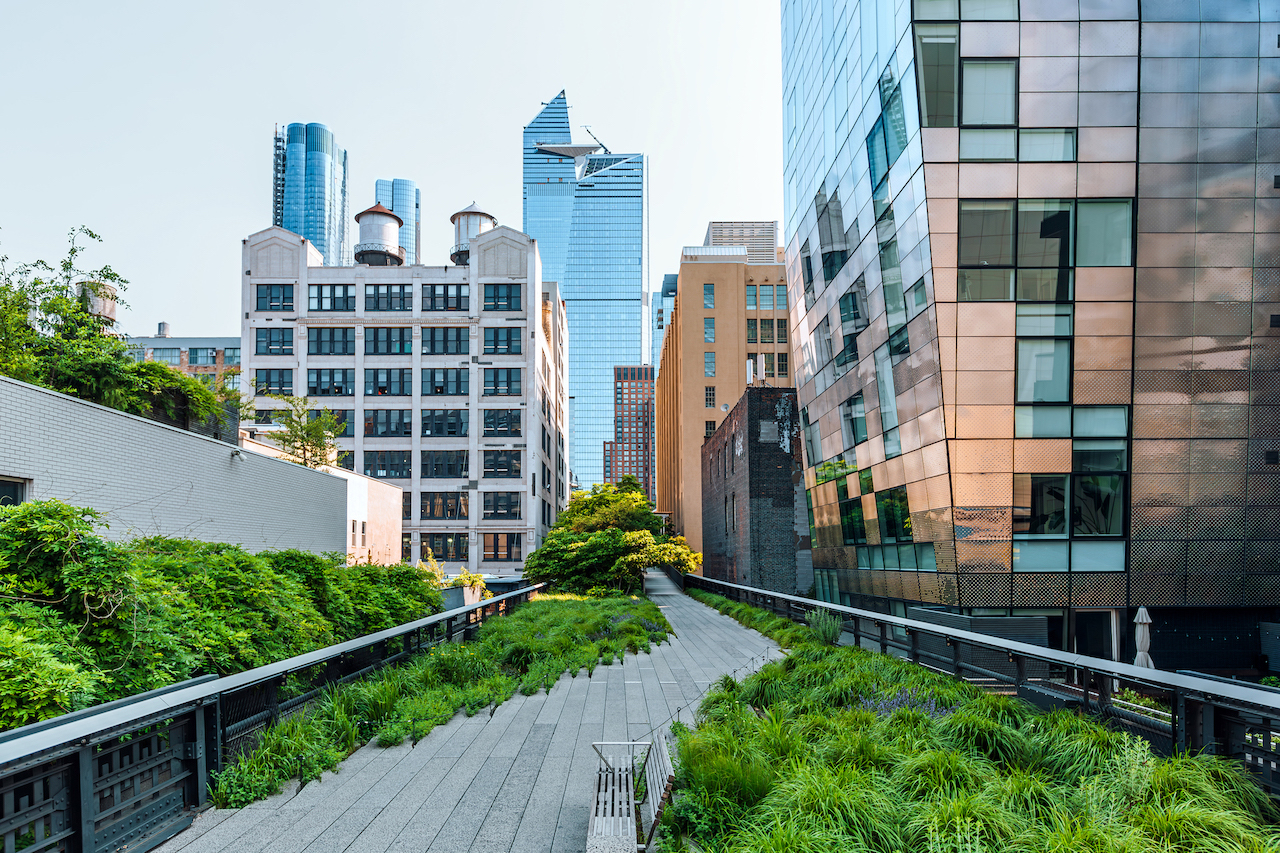 A walkway in the middle of a city surrounded by tall buildings