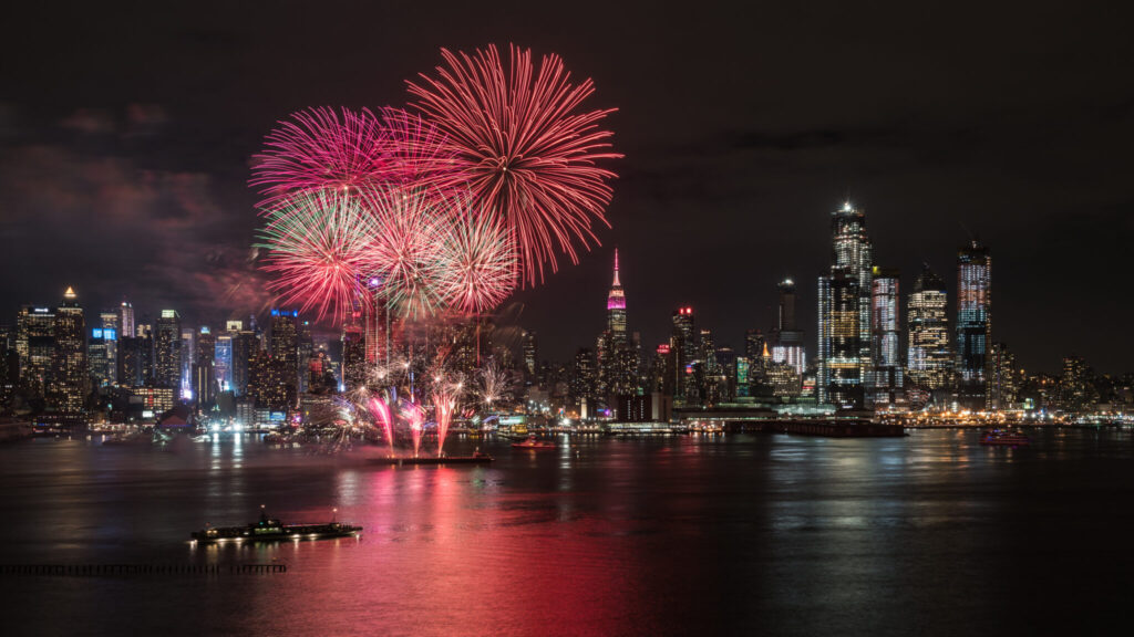 Fireworks burst in the sky above the Hudson River in celebration of the 4th of July