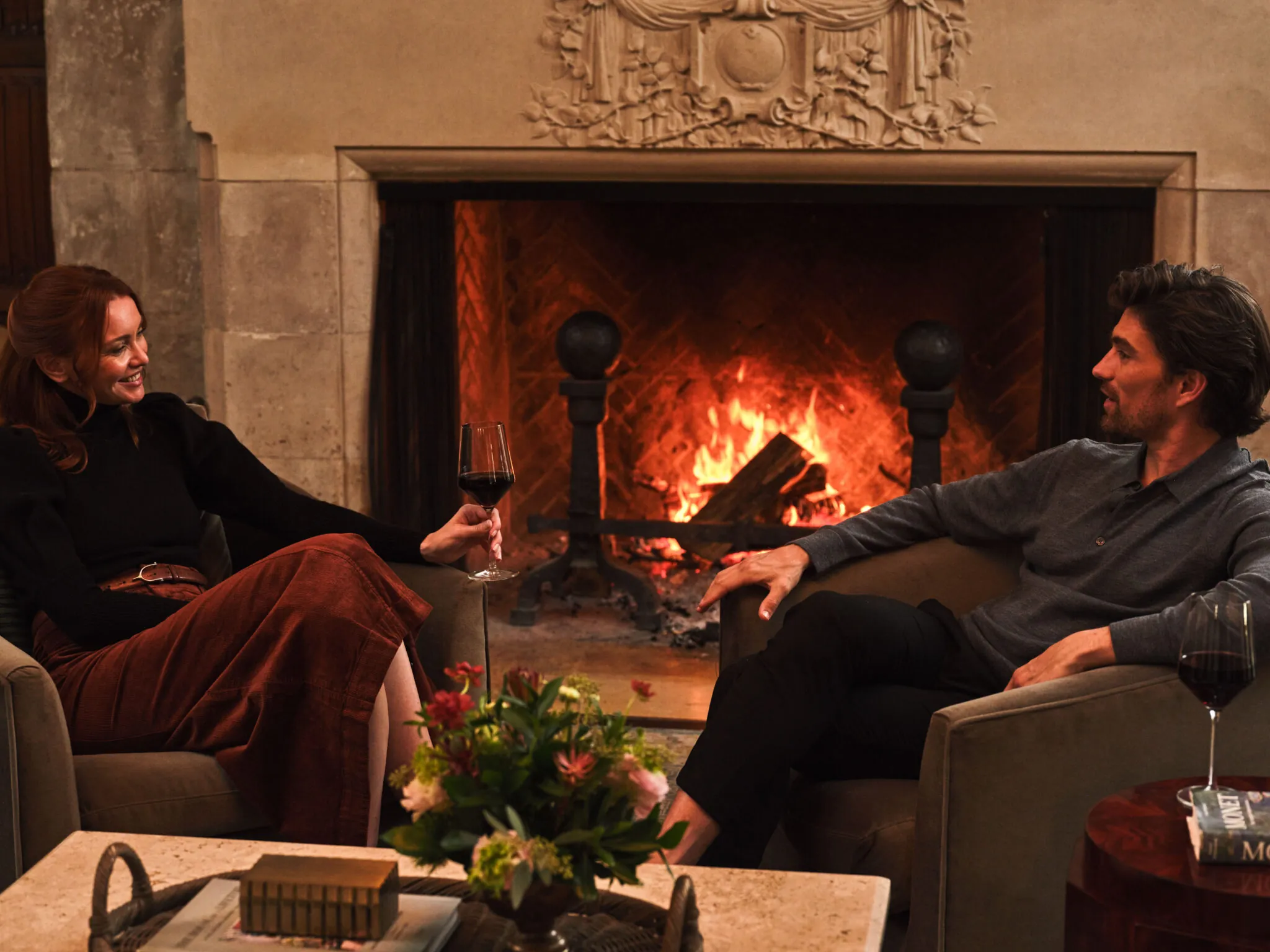 Guests in front of fireplace at Pendry Natirar