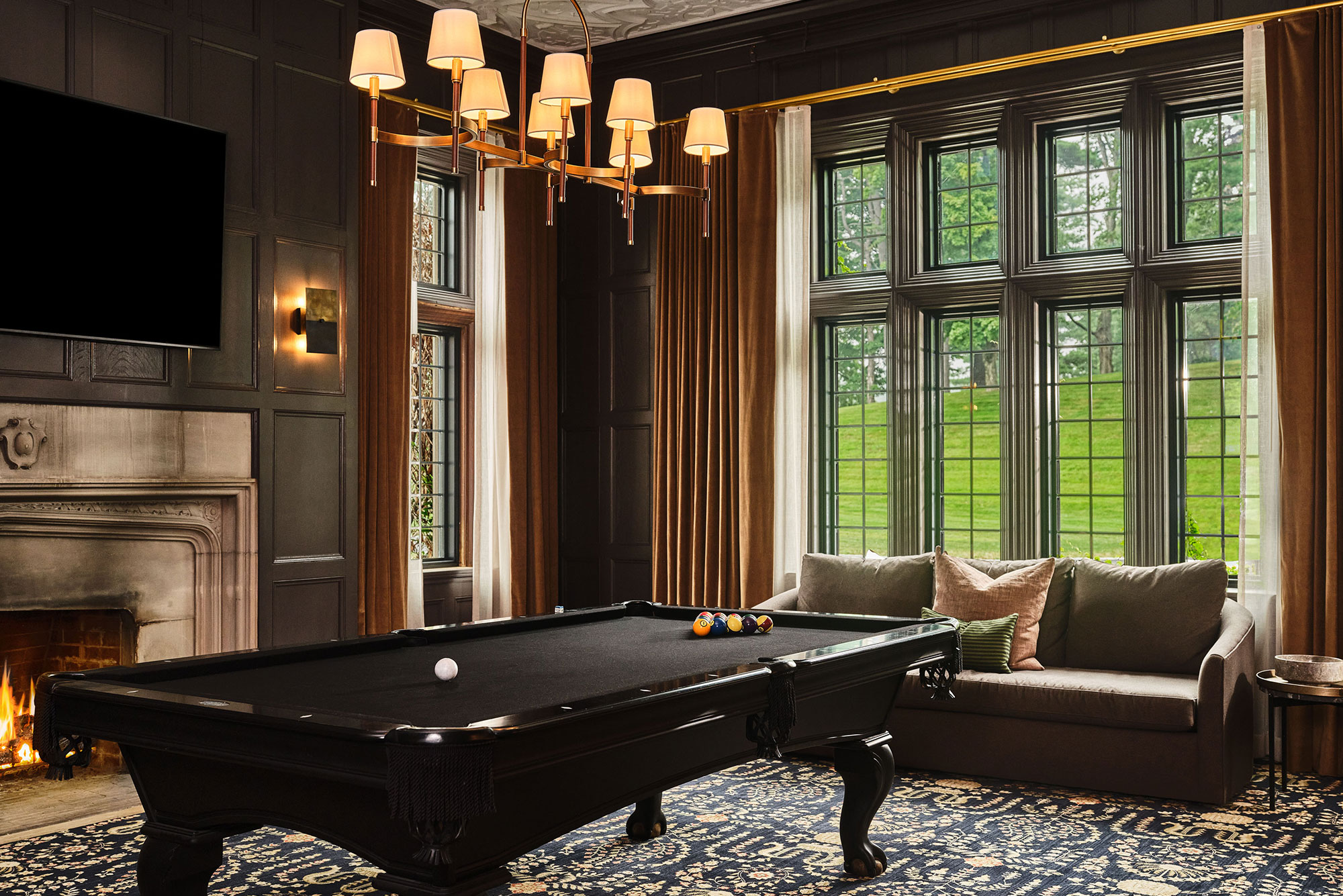 The Billiards Room at Pendry Natirar with fireplace, lounge seating and a billiards table.