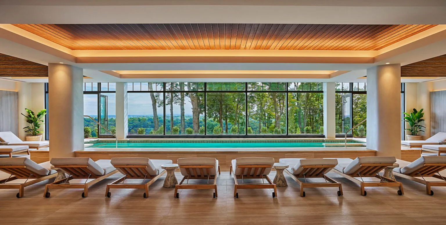 The indoor pool with daybeds next to it at Pendry Natirar