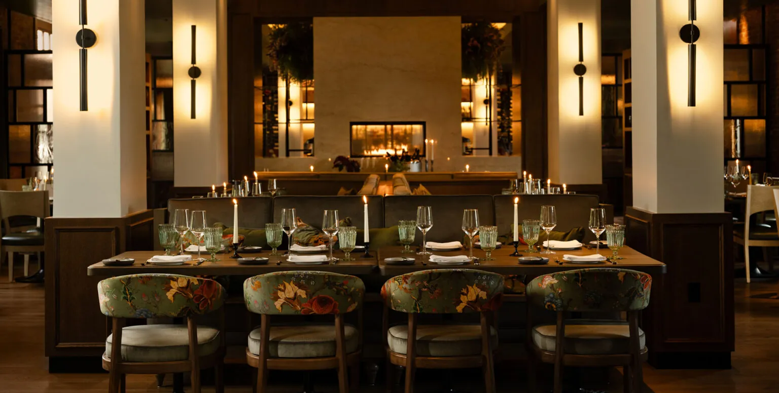 A dining table with floral chairs at Ninety Acres