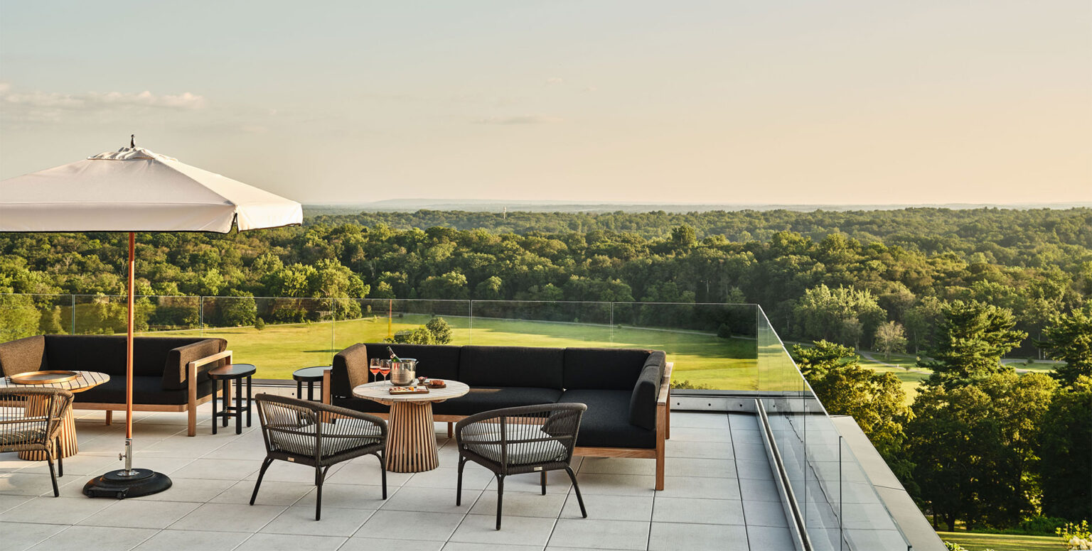A rooftop terrace at Pendry Natirar with couches and chairs