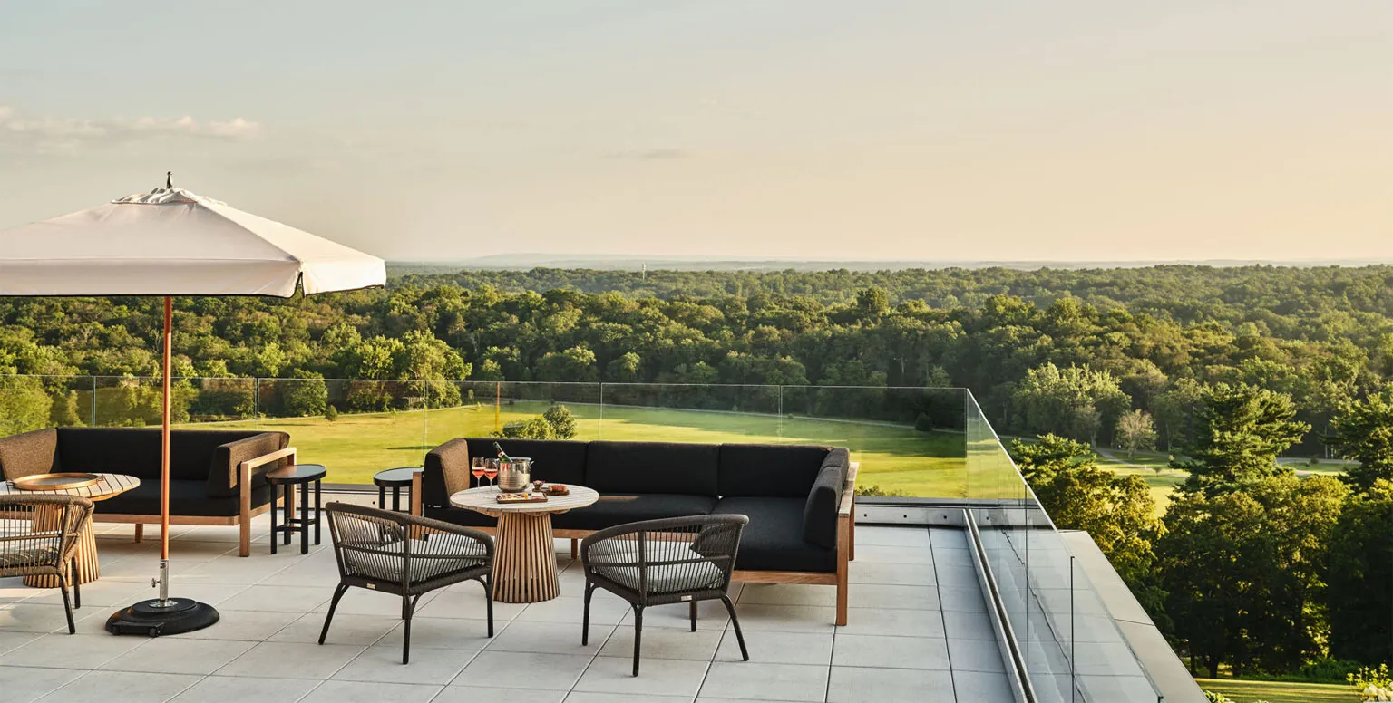 A rooftop terrace at Pendry Natirar with couches and chairs