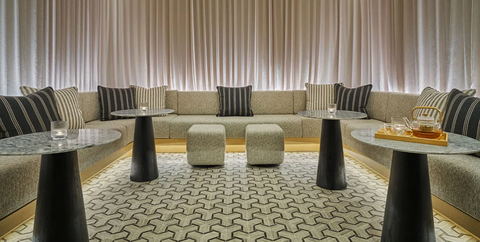 A private waiting room with a large couch at Spa Pendry Natirar