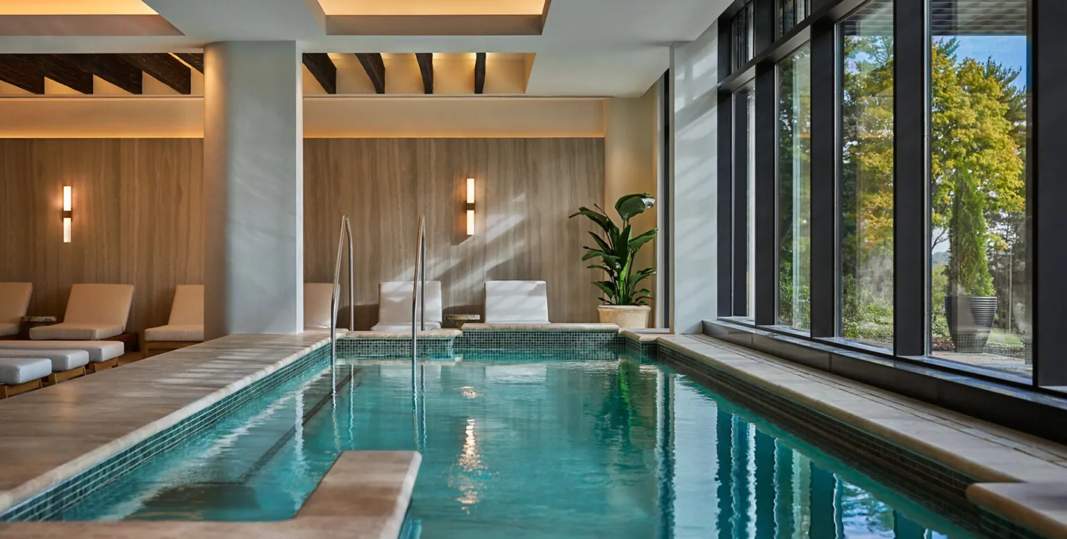 The indoor pool next to floor to ceiling windows at Spa Pendry Natirar