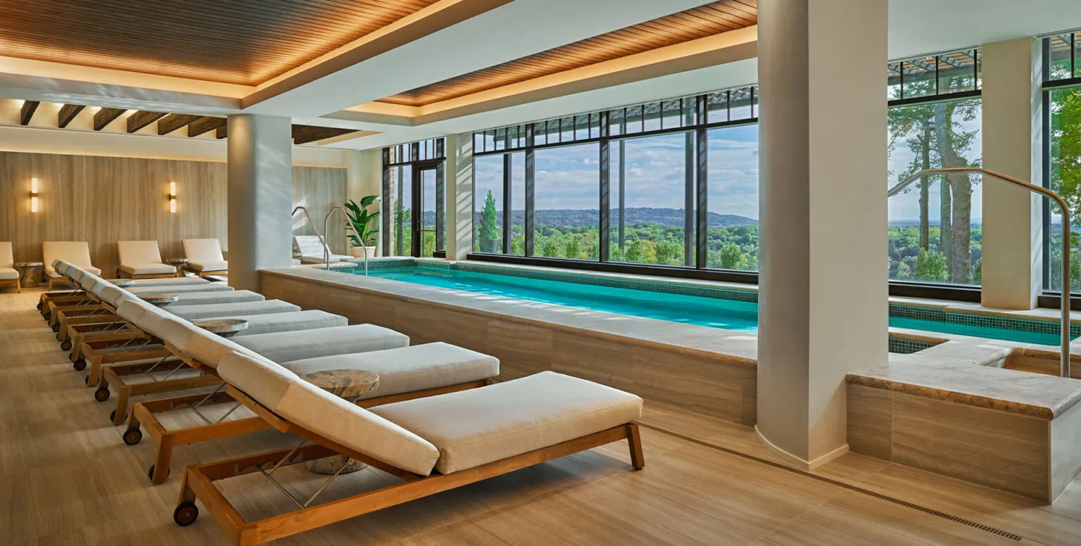 Daybeds by an indoor pool at Spa Pendry Natirar