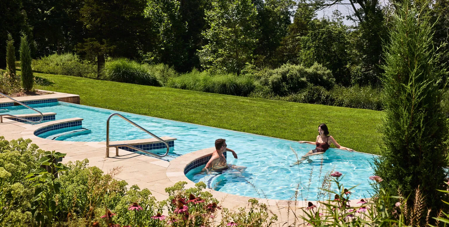 A couple sitting in the pool at Pendry Natirar