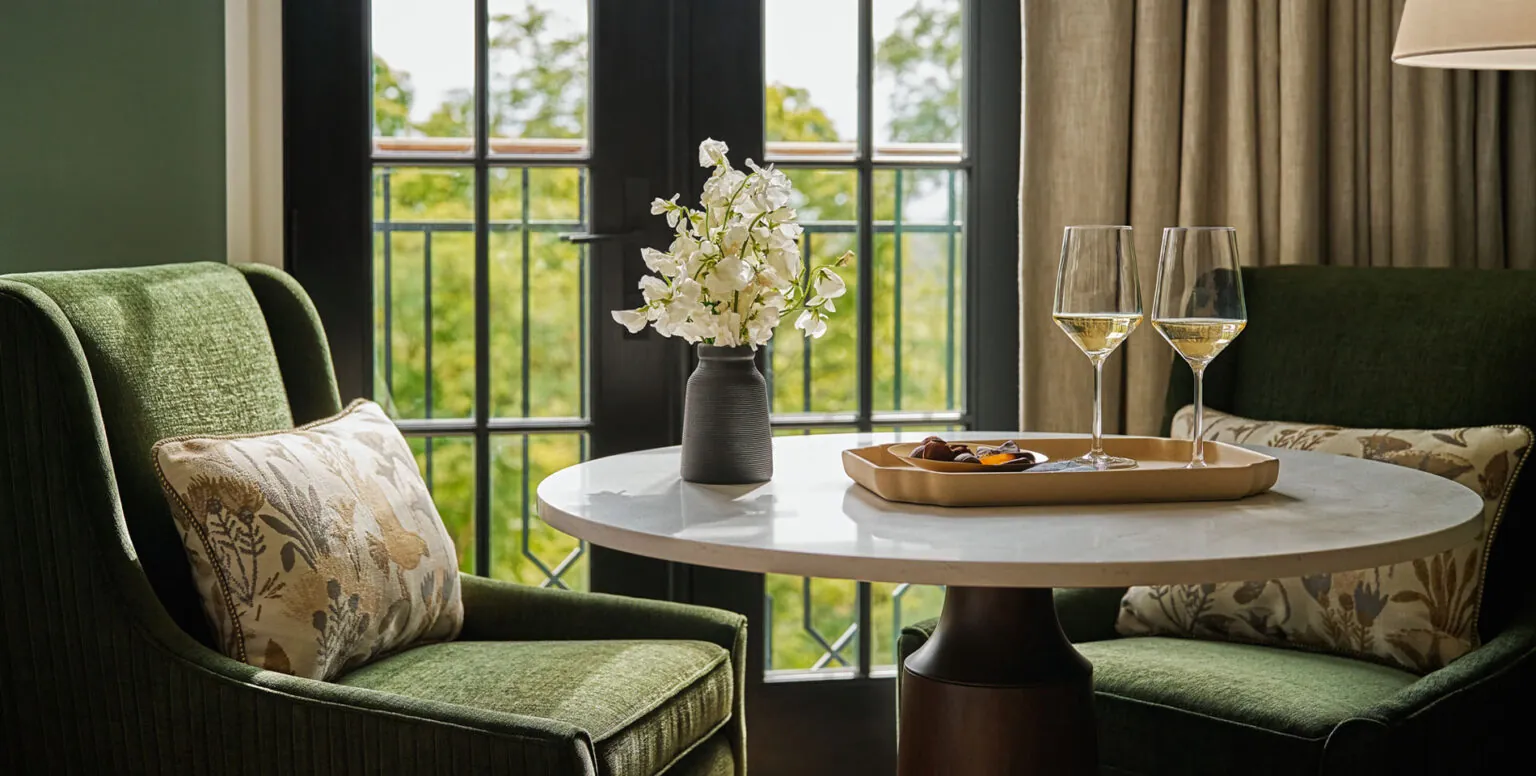 A tray placed on a table with two glasses of wine on it at Pendry Natirar resort