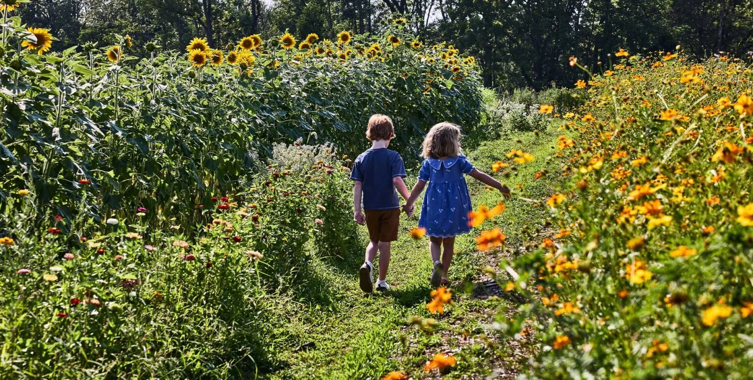 Two children walking through the Farm at Pendry Natirar.