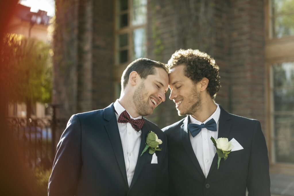 Grooms smiling at each other