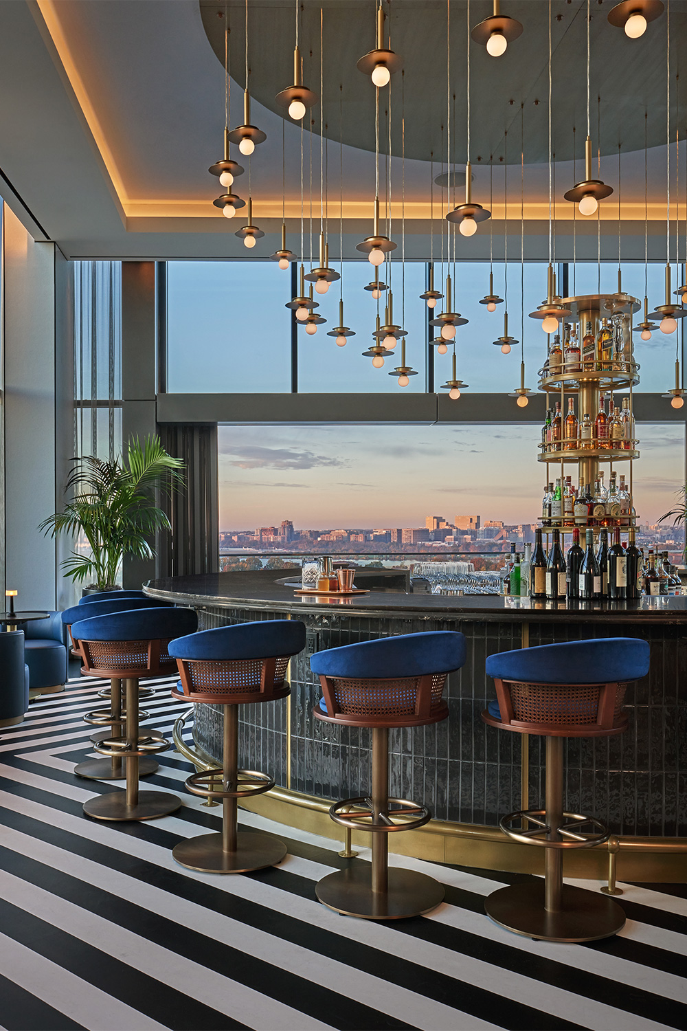 Rooftop bar at Pendry Washington DC with panoramic city views at sunset.